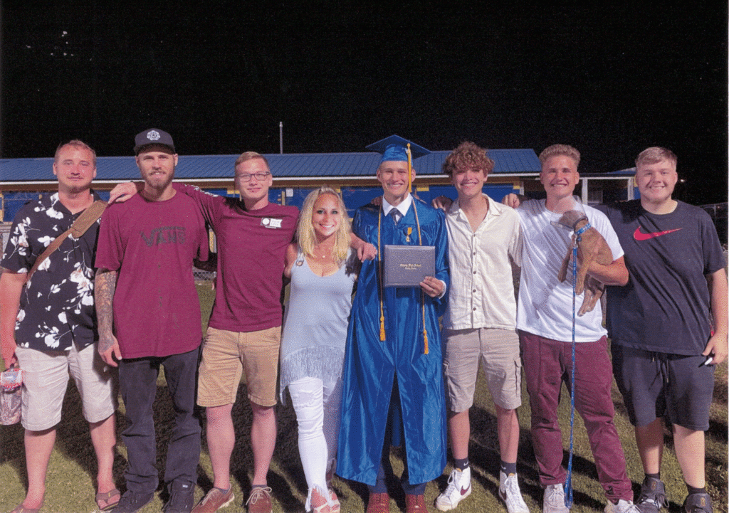 Family of 6 young men and mother standing in the middle of them